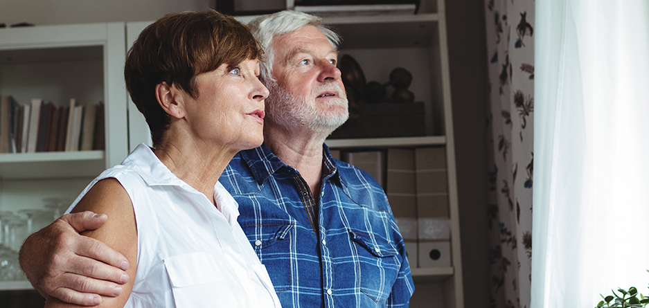 senior-couple-looking-through-window